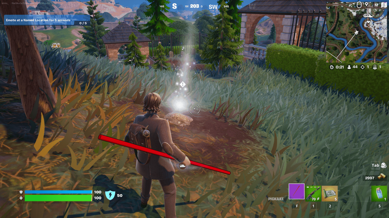Fortnite Cerberus Snapshot: A player standing next to a shining mark on the ground with some trees and buildings in the background.