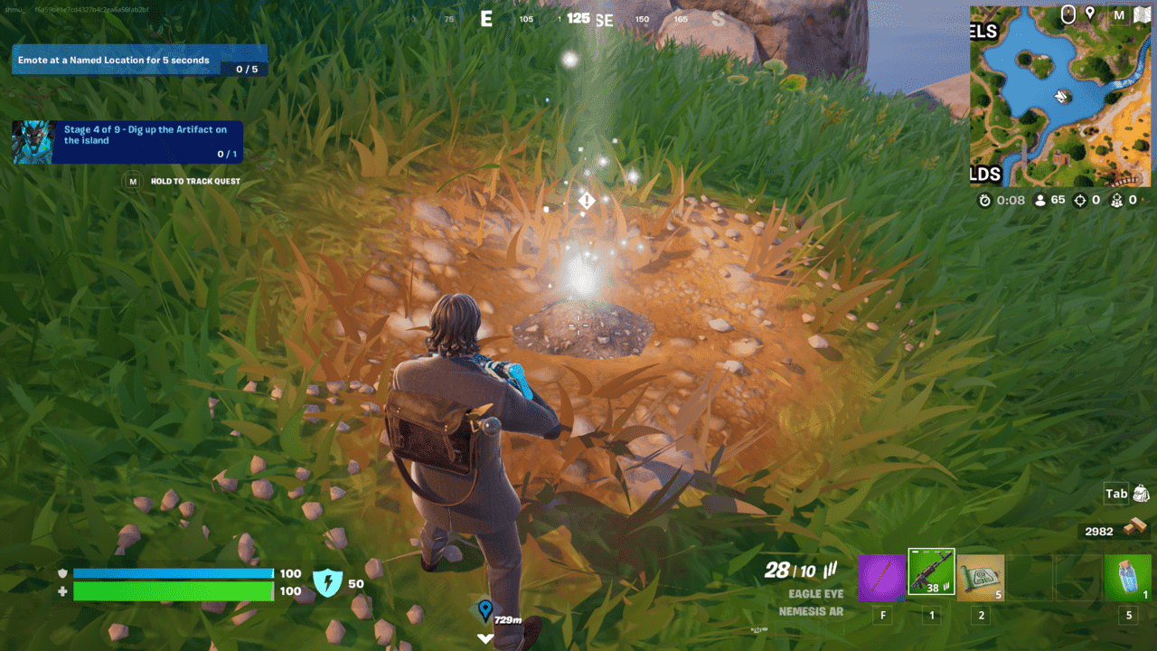 Fortnite Cerberus Snapshot: A player standing above a shining mark on the ground surrounded by grass.
