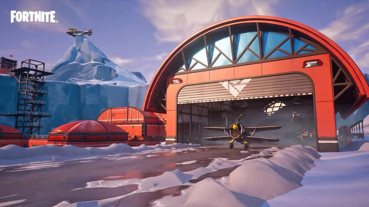 A snow-covered mountain towering over a vibrant red building, showcasing the captivating scenery of a recent Fortnite update.