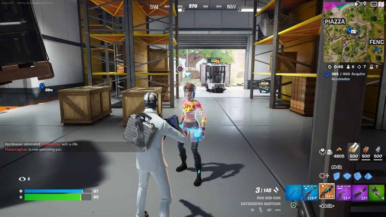 Two players interact in a Fortnite Chapter 5 Season 2 garage setting within a video game, one dressed in a space-themed outfit and the other in casual clothes with a colorful backpack.