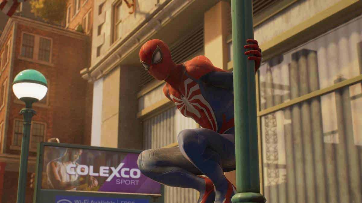 VideoGamer GOTY 2023 - Spider-Man is hanging from a lamp post in Spider-Man 2. Image captured by VideoGamer.