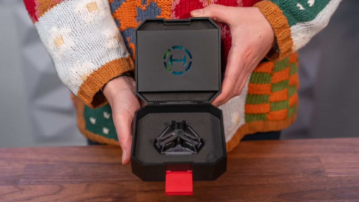 A person is holding a box with a darth vader ring in it.