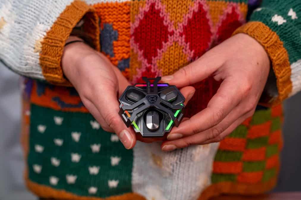 A person holding a small toy in their hands.