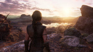 Hellblade 2 chapter list: character Senua standing on a ridge overlooking a vista bathed in late-day sun.