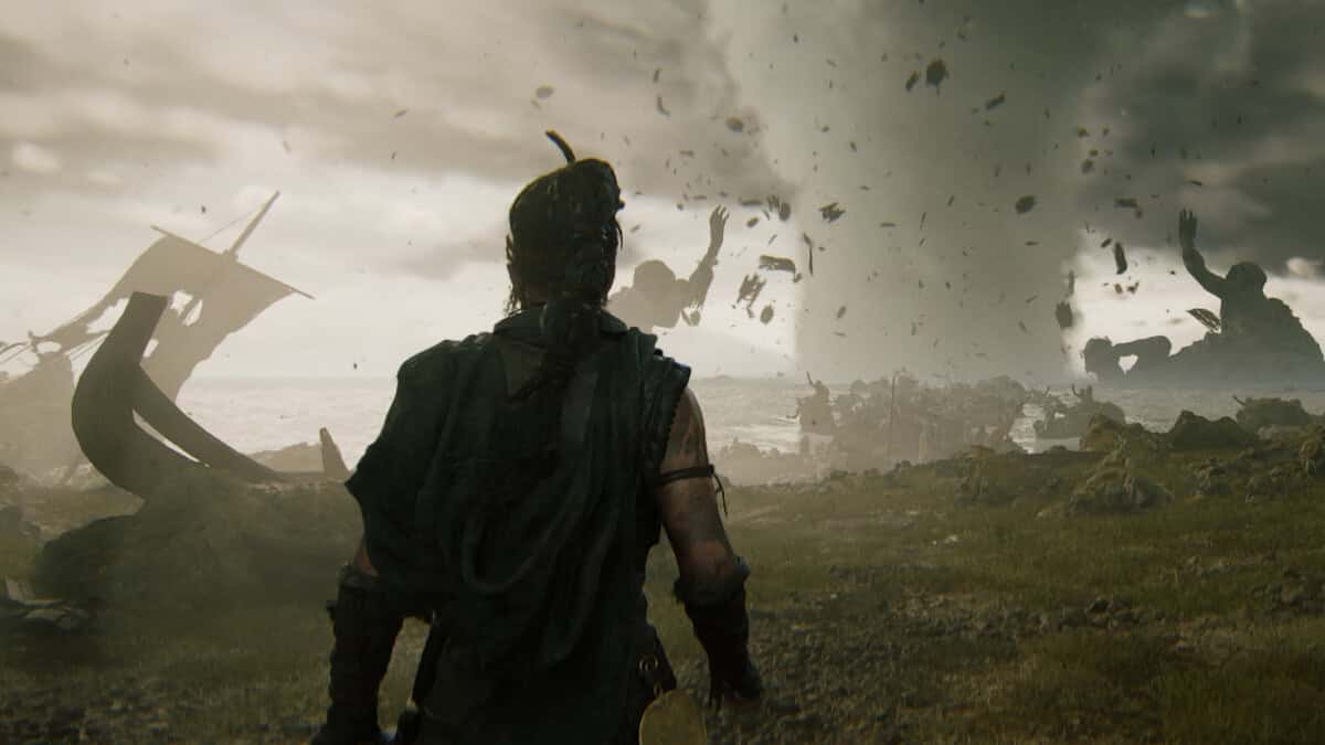 Hellblade 2 cheats and console commands: Senua starring out toward the sea, a giant, and a large tornado.