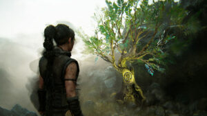Hellblade 2 Hidden Faces locations: Senua facing a small, leafy tree with a glowing spiral symbol on its trunk.