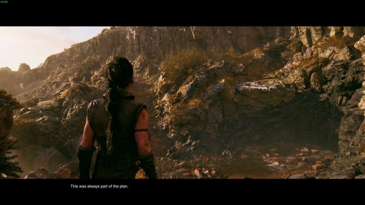 Hellblade 2 Lorestangir locations: Senua stands in front of the rocky, mountainous terrain.