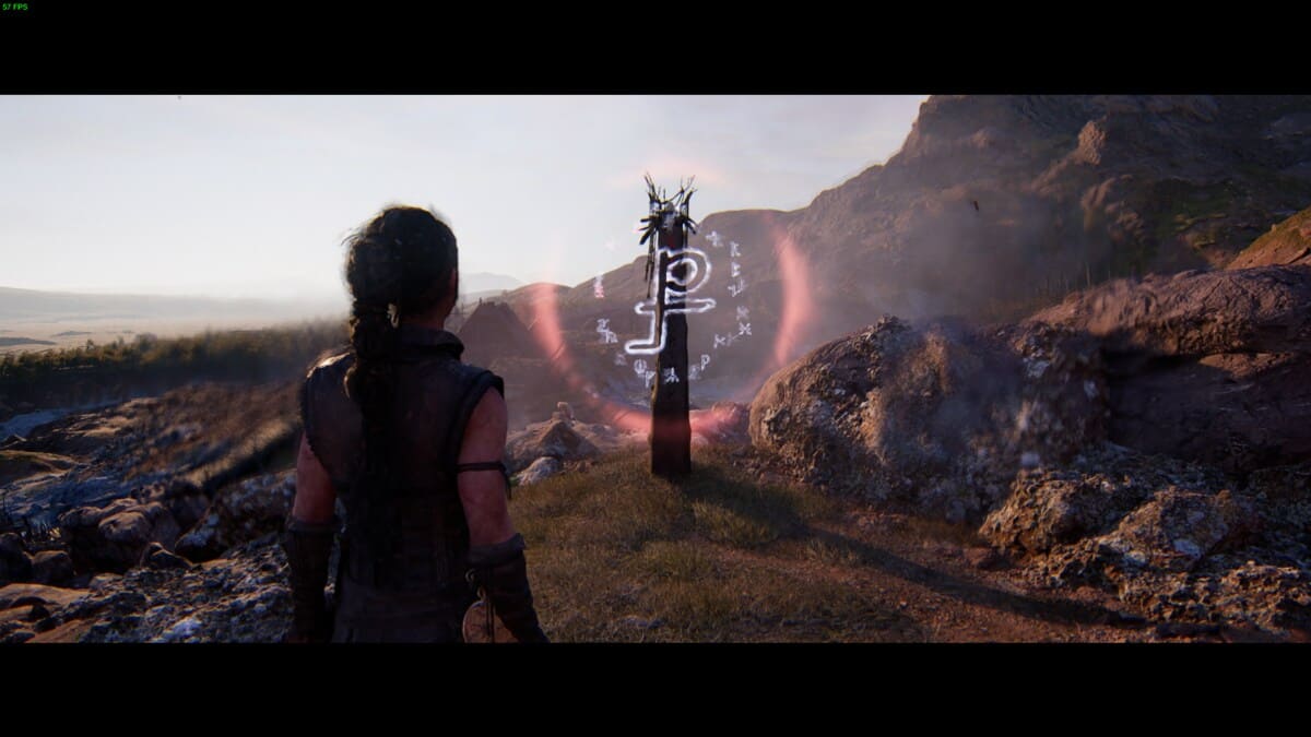 Hellblade 2 Lorestangir locations: Senua overlooking a hill near a runic totem