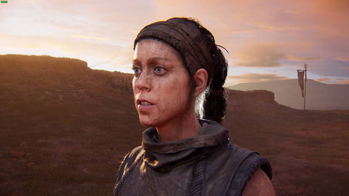 Hellblade 2 Lorestangir locations: Senua stands outdoors at sunset with hills and a flag in the background.