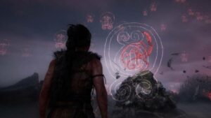 Hellblade 2 mods: protagonist Senua stands facing intricate, glowing symbols in dark environment.