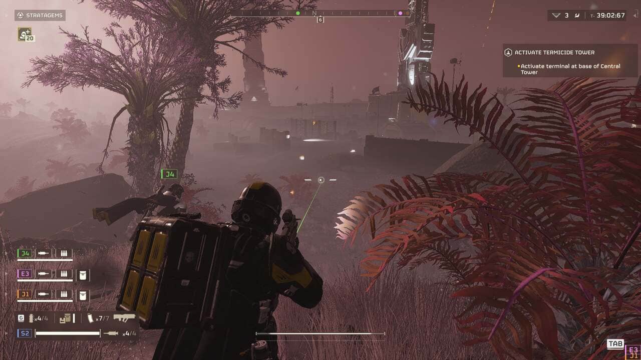 A player character in a Helldivers 2 suit traverses a gloomy, alien landscape with industrial structures in the distance, armed and ready for combat in a video game environment.