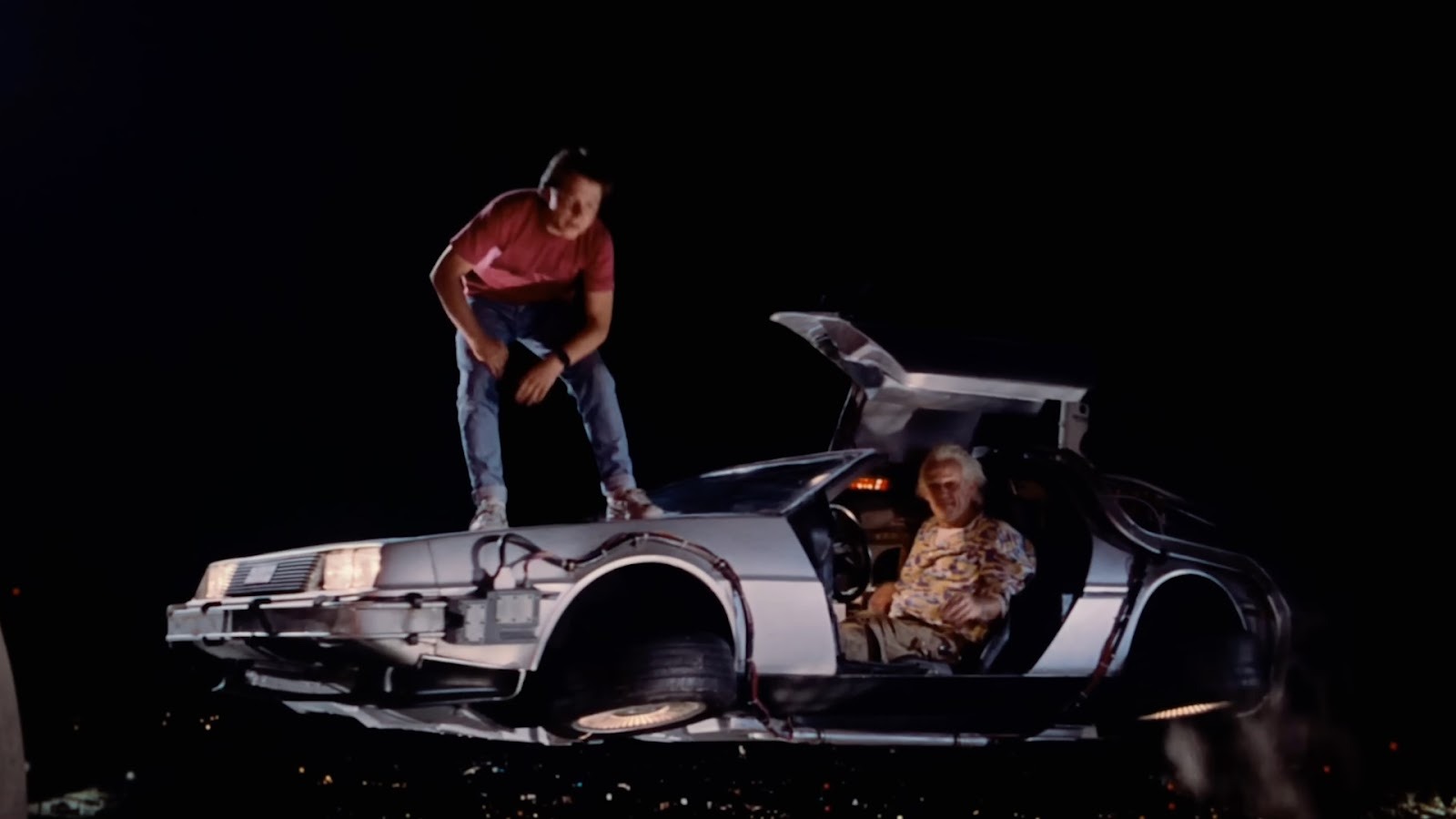 Back to the Future - Marty and Doc Brown pose in the Delorean