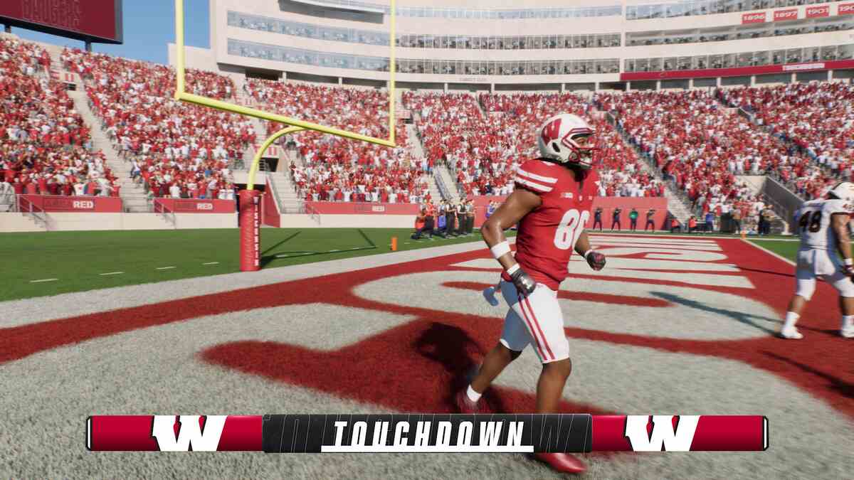 Is College Football 25 crossplay: A player in a red jersey celebrating scoring a touchdown.