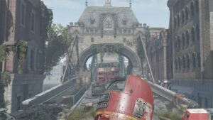 Is Fallout London on console: A view of an overgrown, post-apocalyptic Tower Bridge with several cars and London buses broken down.