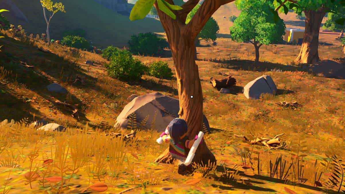 A man is standing next to a tree in a grassy area, showcasing his LEGO Fortnite skills.