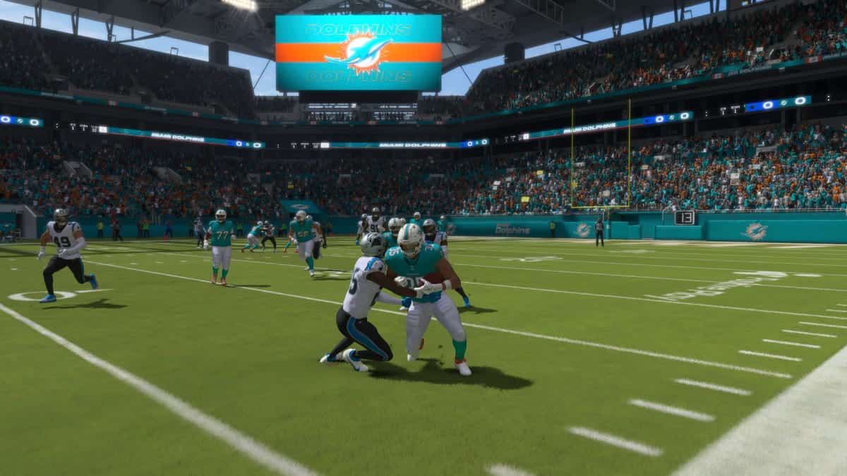 The Miami Dolphins are playing a football game in a stadium, showcasing their skills in Madden 24.