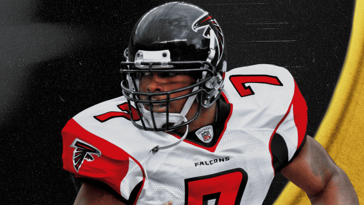 The Atlanta Falcons football player, Michael Vick, is holding a football.