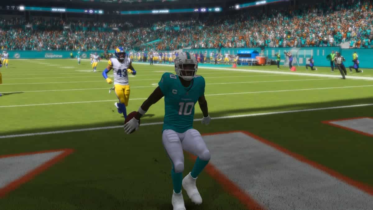 The Miami Dolphins player is running on the field, showcasing impressive speed and agility.