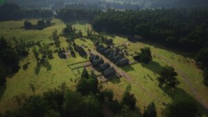 Manor Lords build order: aerial view of a rustic village with thatched-roof houses, scattered trees, and dirt pathways in a lush green landscape.