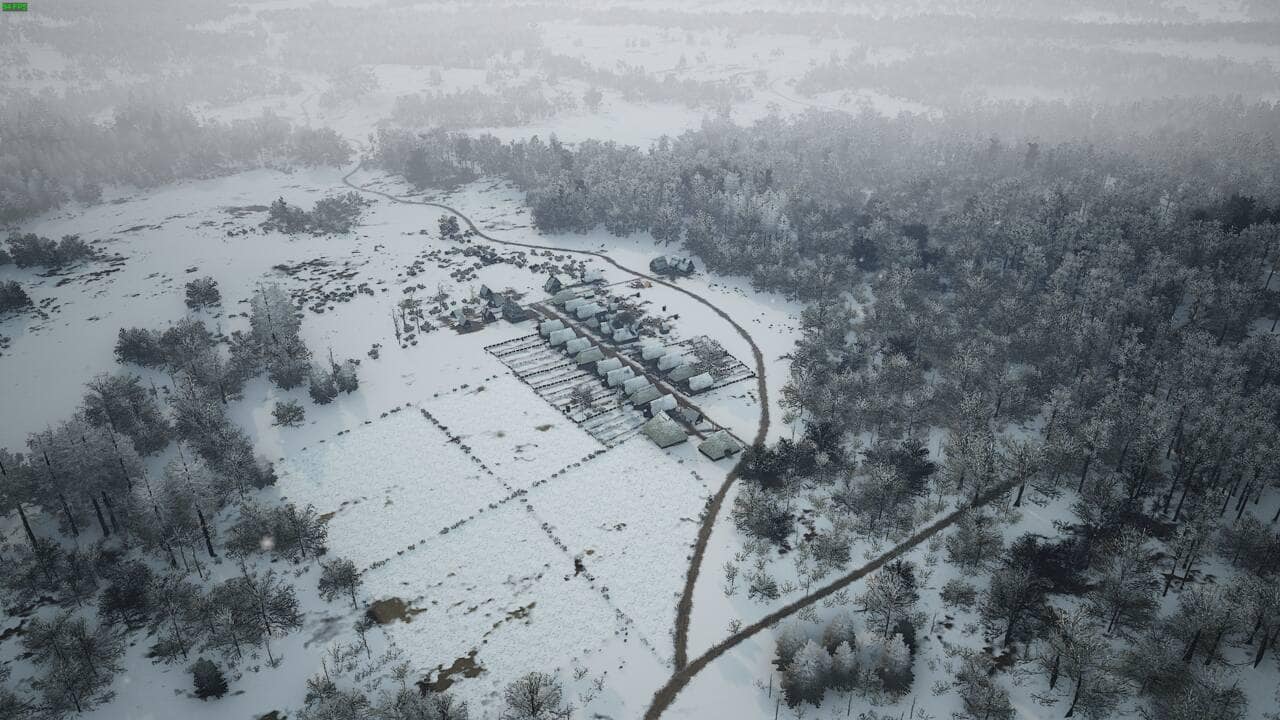 Manor Lords build order: medieval village from the air carpeted in snow.