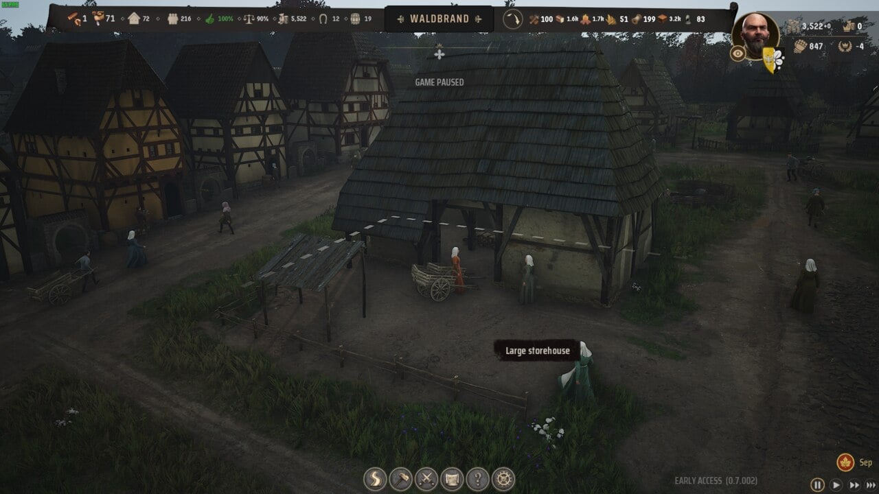 Manor Lords buildings: Medieval village scene in a video game with half-timbered houses, villagers walking, and a central Manor Lords building.