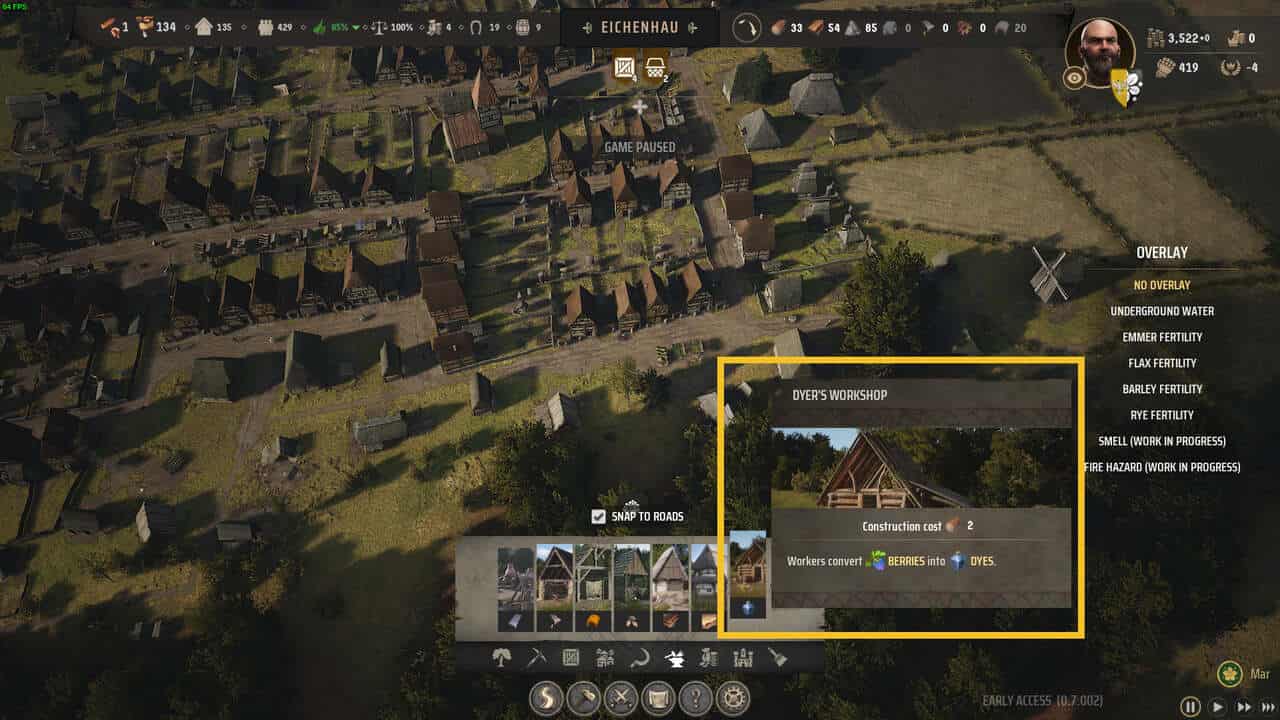 Manor Lords Dyes: a medieval town layout with an open construction menu with the Dyer's Workshop highlighted in yellow.