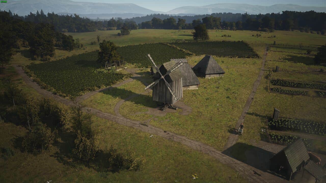 Manor Lords windmill not working: view of a rustic village with a large windmill surrounded by agricultural fields and tree-lined paths.