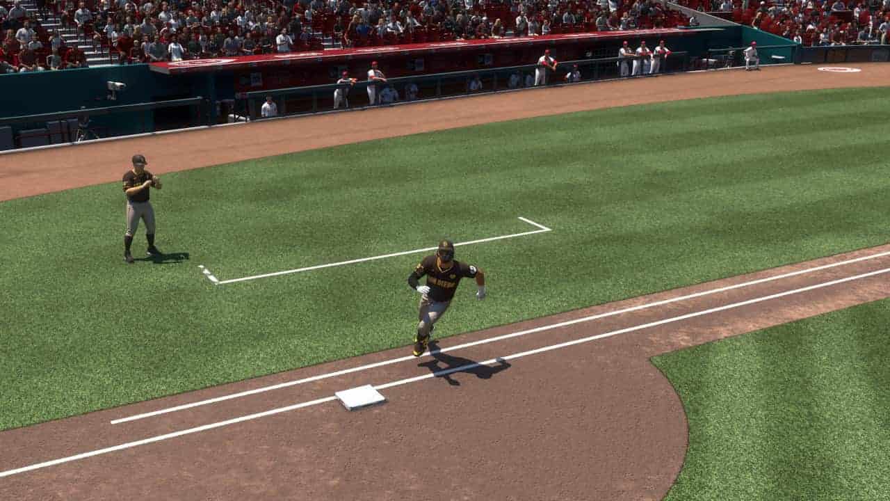 Baseball player learning how to steal bases in MLB The Show 24, running towards first base during a game.