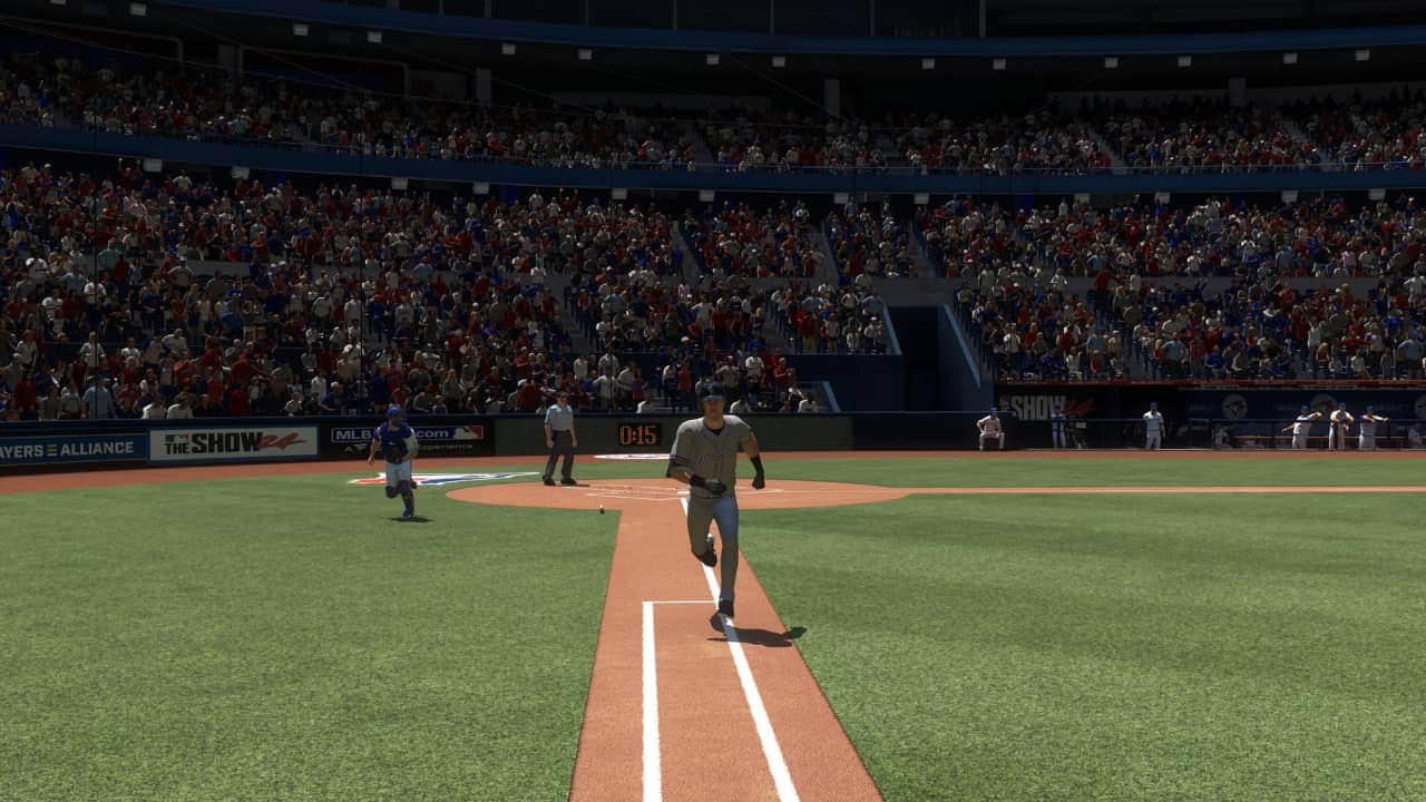 Baseball player running towards first base in a crowded stadium during an MLB The Show 24 match.