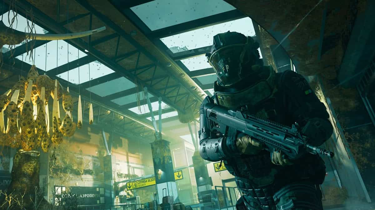 A heavily armed soldier wearing a gas mask, sprints with an assault rifle.