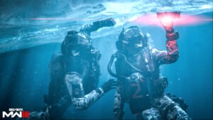 Two soldiers are holding a flashlight while submerged in water.