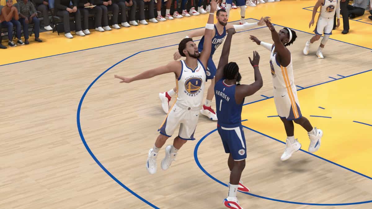 The golden state warriors are playing basketball in a game, with Klay Thompson's NBA 2K24 rating slashed in the latest update.