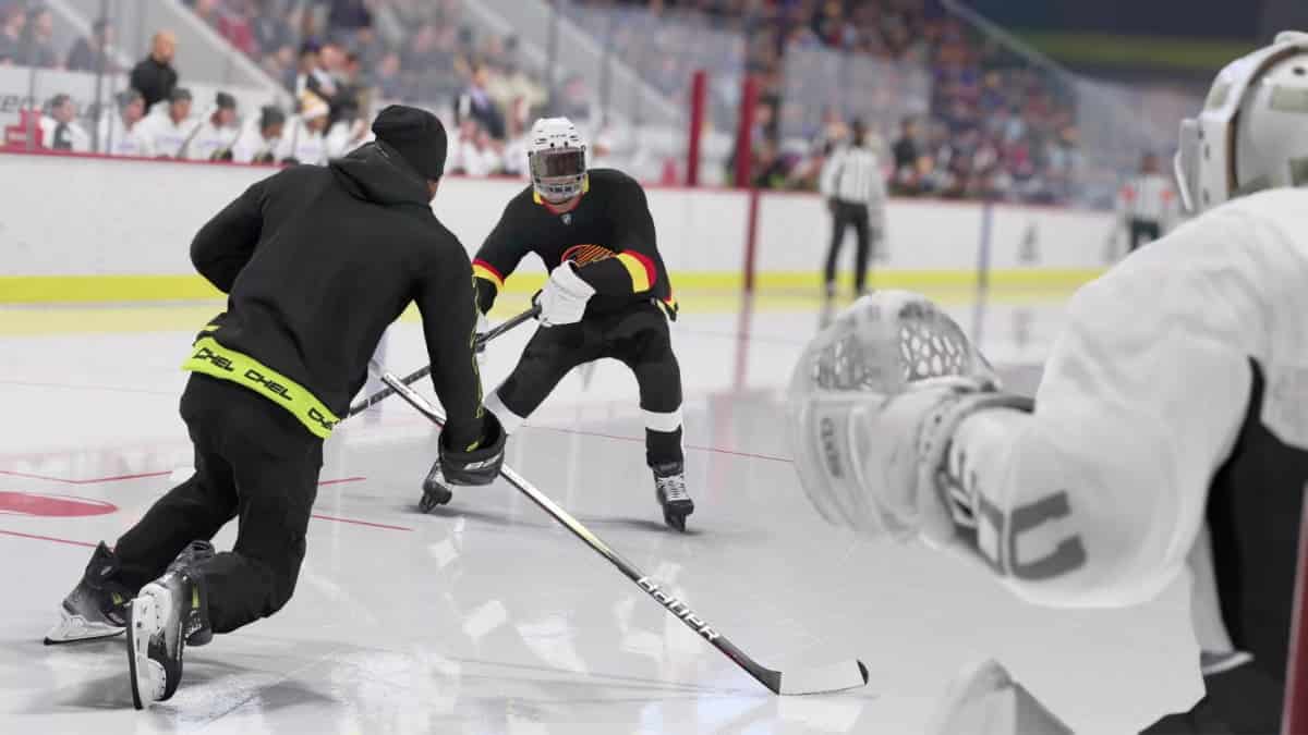 Two NHL hockey players are playing on an ice rink.