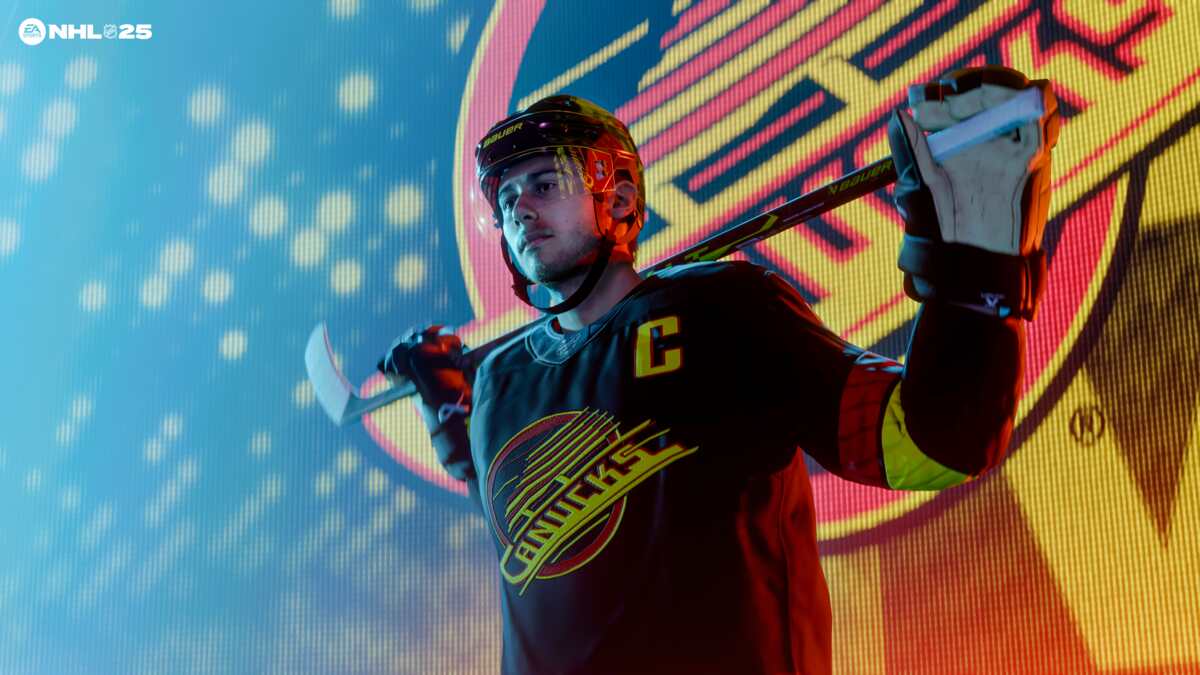 NHL 25 preview: Quinn Hughes in a Canucks jersey holding a hockey stick across his shoulders.