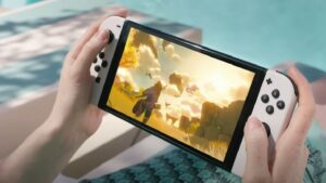 A woman is holding a Nintendo Switch OLED and playing a game.