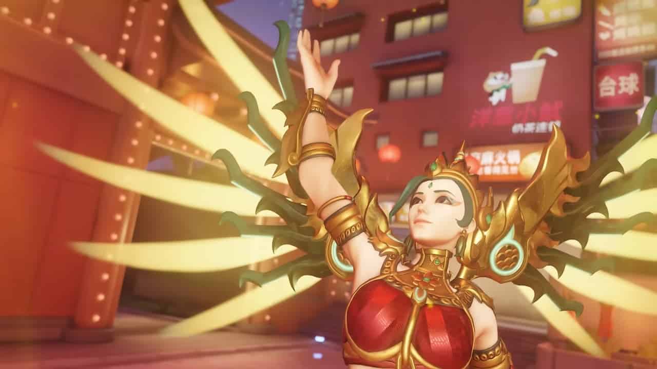 Mercy with golden wings lifting her arm up in Overwatch 2