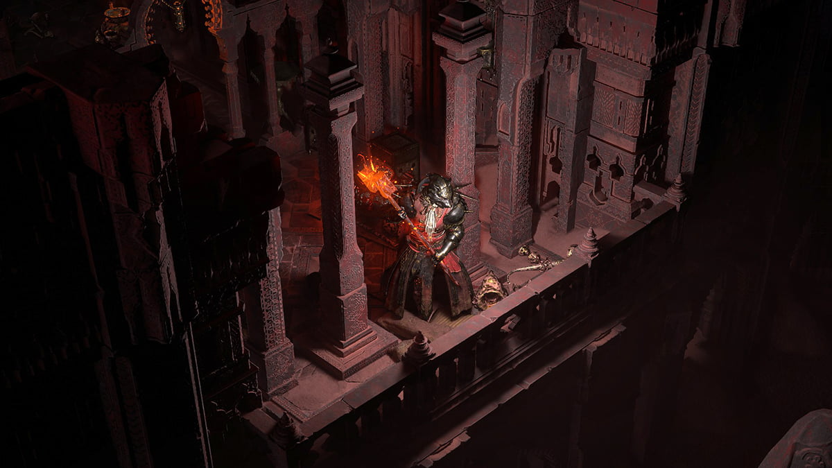 Image of the Warrior Titan class character with a flaming hammer standing on a balcony in underground catacombs of Path of Exile 2.