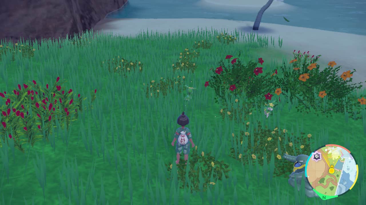 A girl is standing in a field of flowers, attempting to sneak up on Pokemon using the Pokemon Indigo Disk.