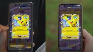 A person is holding a phone with two Pokémon cards on it.