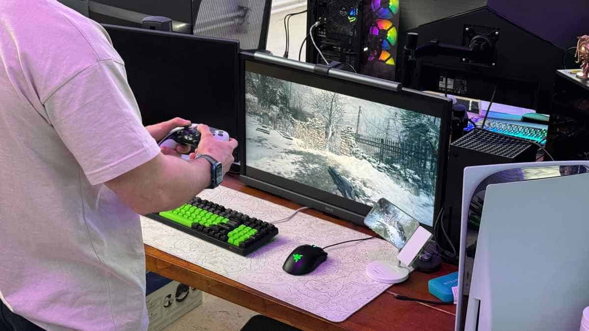 Despite Nintendo's financial success, a man is seen playing a video game on a desk using the Switch 2.