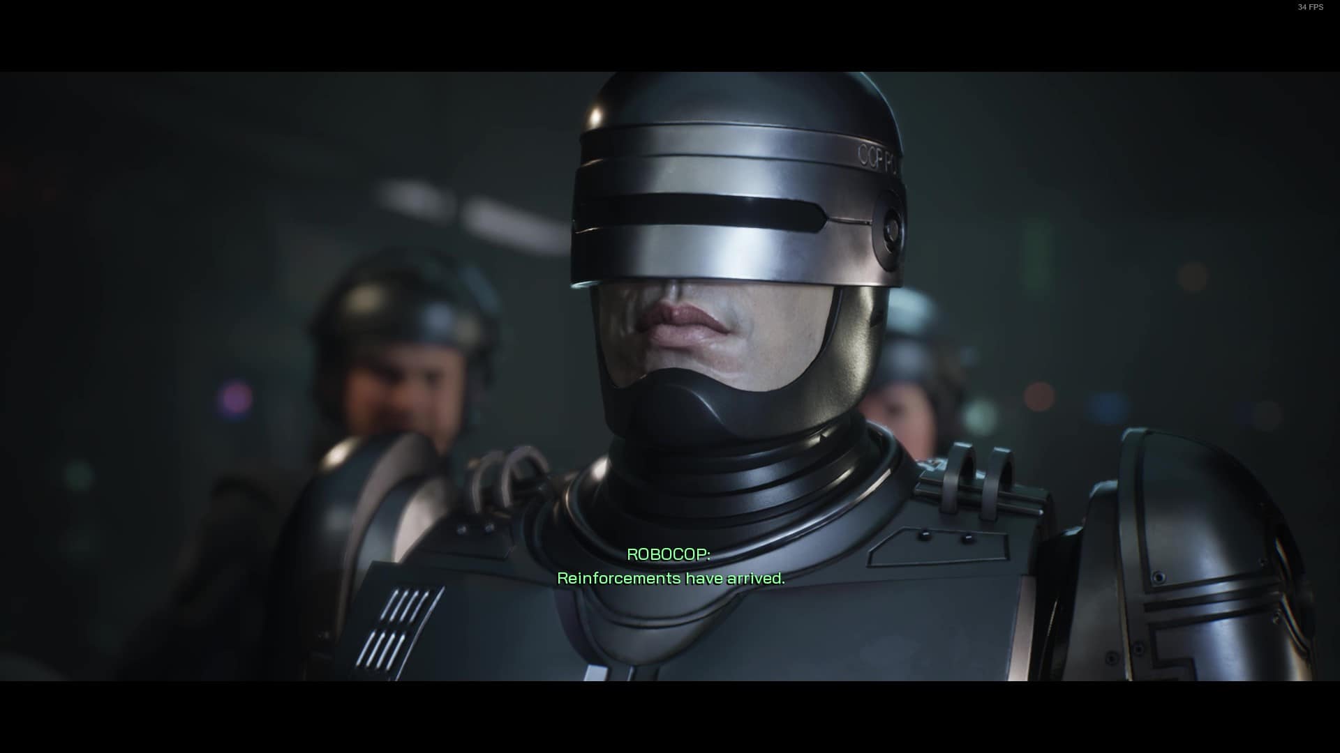 RoboCop Review: RoboCop standing in front of two other police officers.