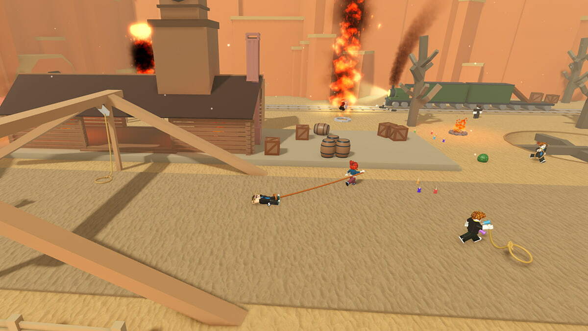 Rope Battles players in the arena. There's a wooden house on the left side, and various wooden props around the arena. A fire is burning in the background.