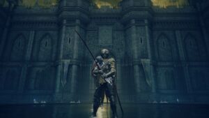 Shadow of Erdtree Remembrances: A player standing in a castle in shallow water in front of a large stone wall.
