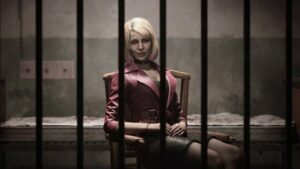 A blond woman in a trench coat is seen behind bars