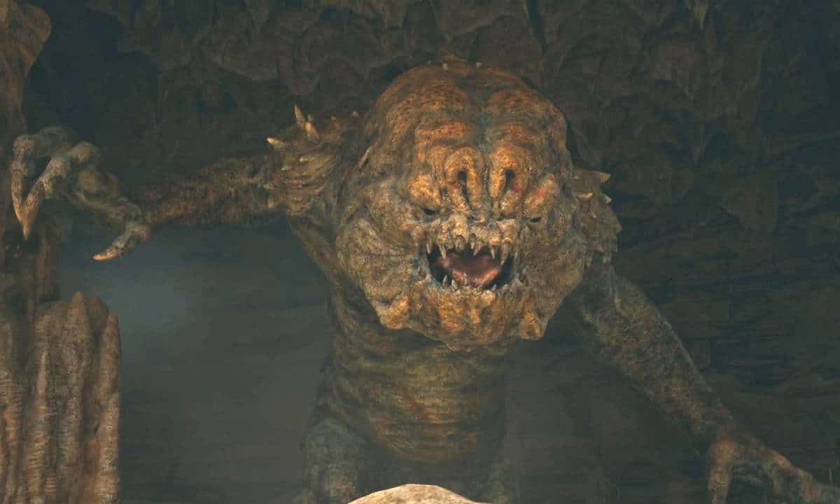 Star Wars Jedi Survivor Rancor boss: The Rancor opening cutscene emerging from behind the rocks.