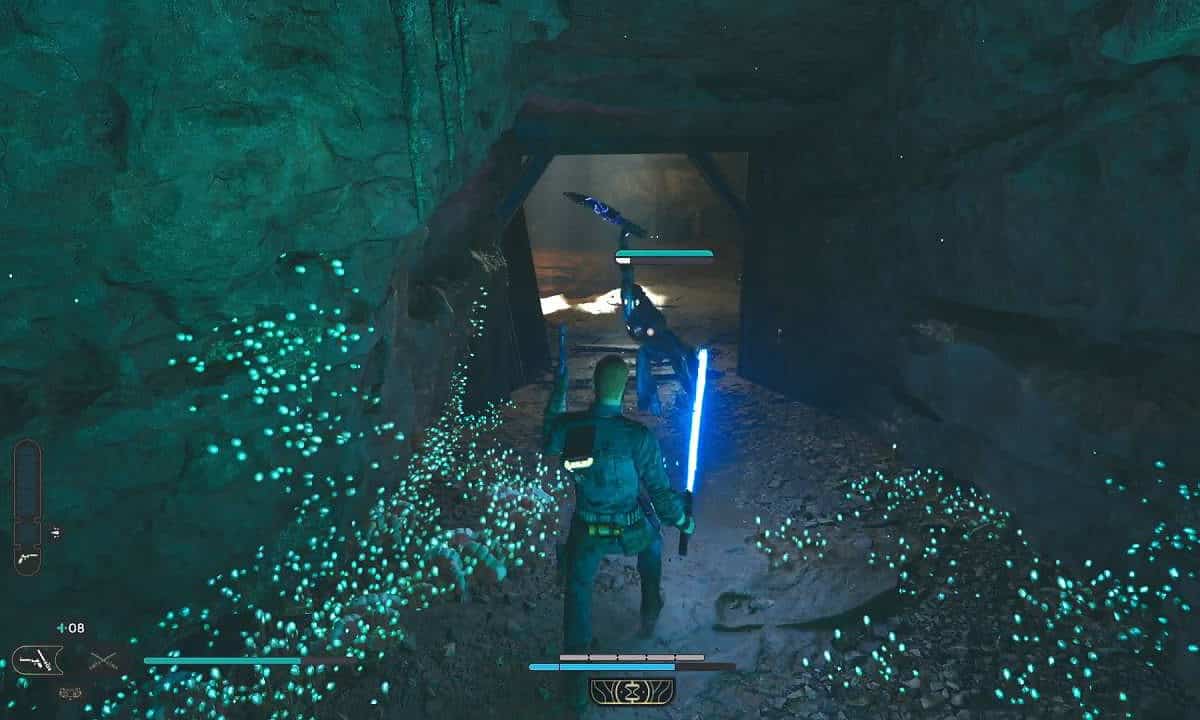 Star Wars Jedi Survivor review: Cal fighting a BX Droid with his blue lightsaber in a glow-in-the-dark tunnel.
