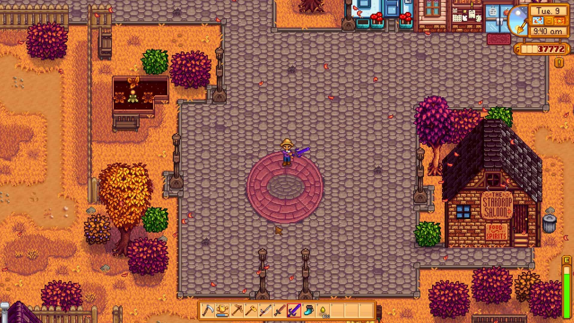 Stardew Valley cheats: A player standing in the centre of town swinging a Galaxy Sword.