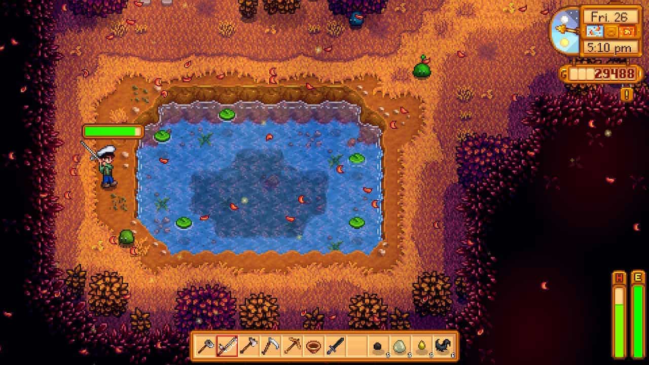 A character fishing for Stardew Valley Woodskip in a pond during autumn at dusk in the game Stardew Valley.