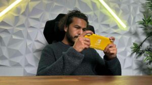 A man holding a yellow Nintendo Switch 2.