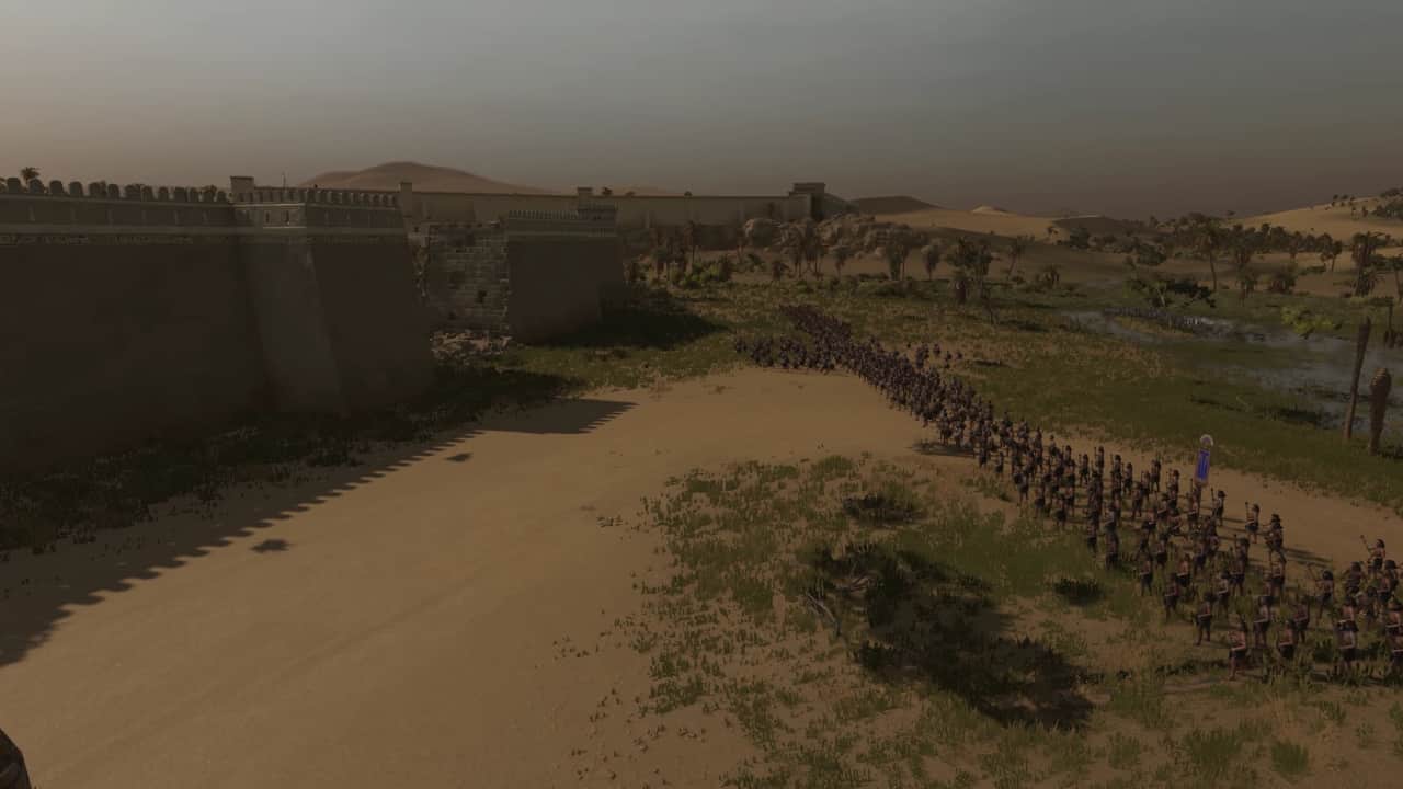 Total War Pharaoh tips and tricks to help you beat the game: Armies storm the battered walls of a fortified city.